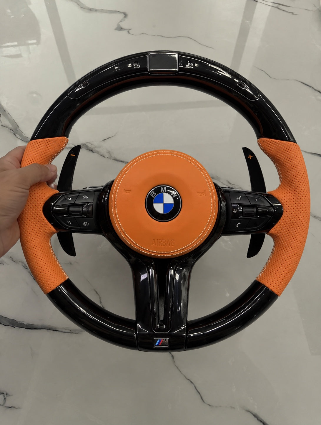 Front view of BMW orange leather gloss black LED steering wheel
